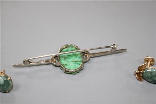 A 9ct white metal and carved oval jade plaque set bar brooch and a pair of 14k and simulated jade earrings,